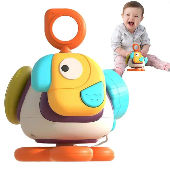 Bird sensory toy with an orange ring, textured side pieces, and a baby shown beside it