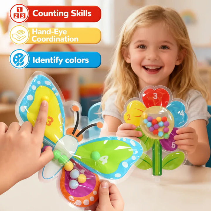 Child holding a flower bead maze while hands move beads in a butterfly design