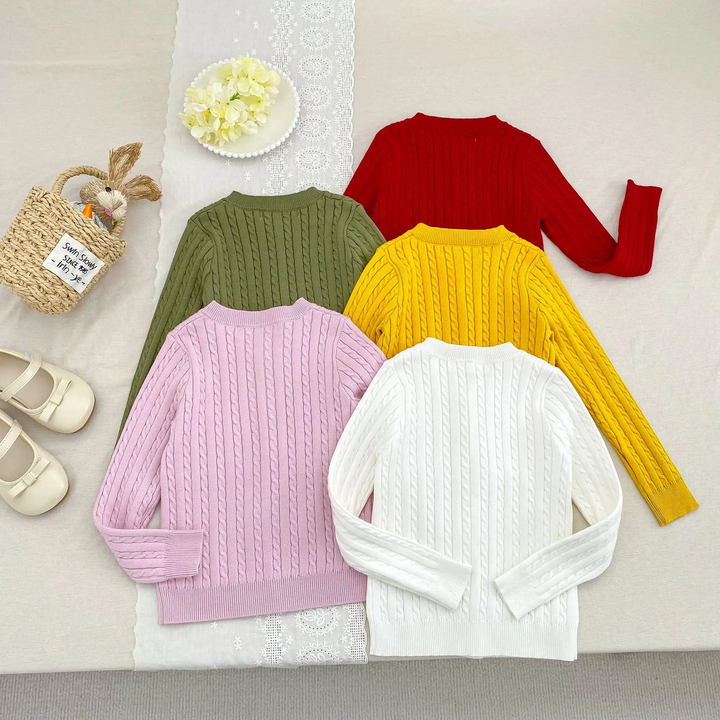 Back views of cable-knit cardigans in green, red, yellow, pink, and white