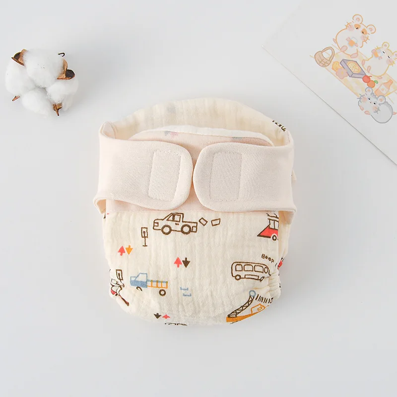 Vehicle-print cloth diaper with cars, buses, and a cream hook-and-loop waistband