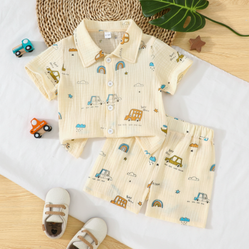 Cream car-print collared shirt and matching shorts laid flat on white bedding