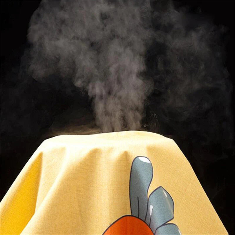 Vapor rising above yellow carrot-print changing-mat fabric in a demonstration.