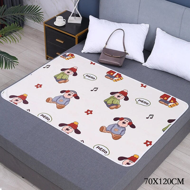 White changing mat with cartoon dogs and musical notes on a bed, labeled 70 x 120 cm.