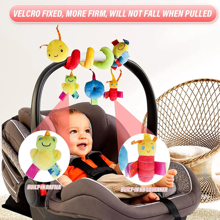 Baby in a car seat beneath a caterpillar spiral toy with hanging plush characters