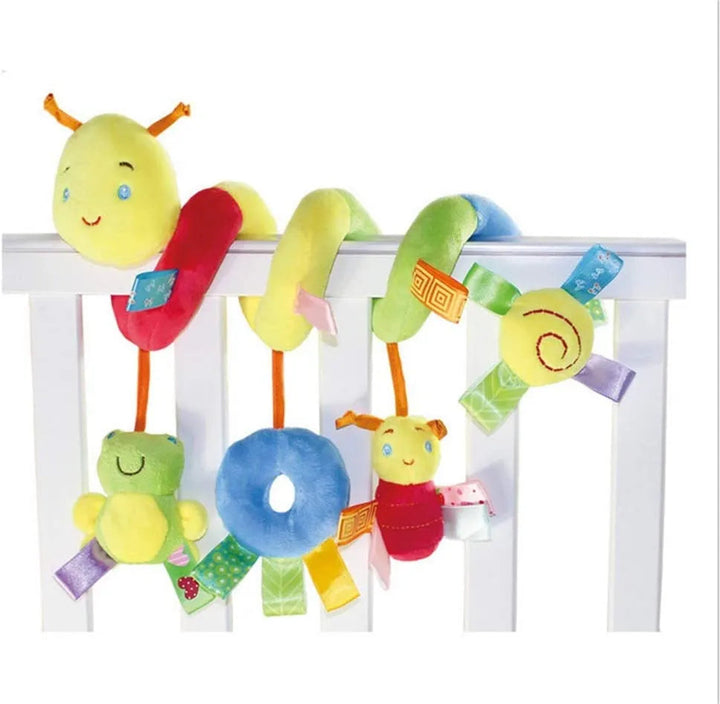 Caterpillar plush spiral on a white rail with a hanging frog, blue ring, and red character