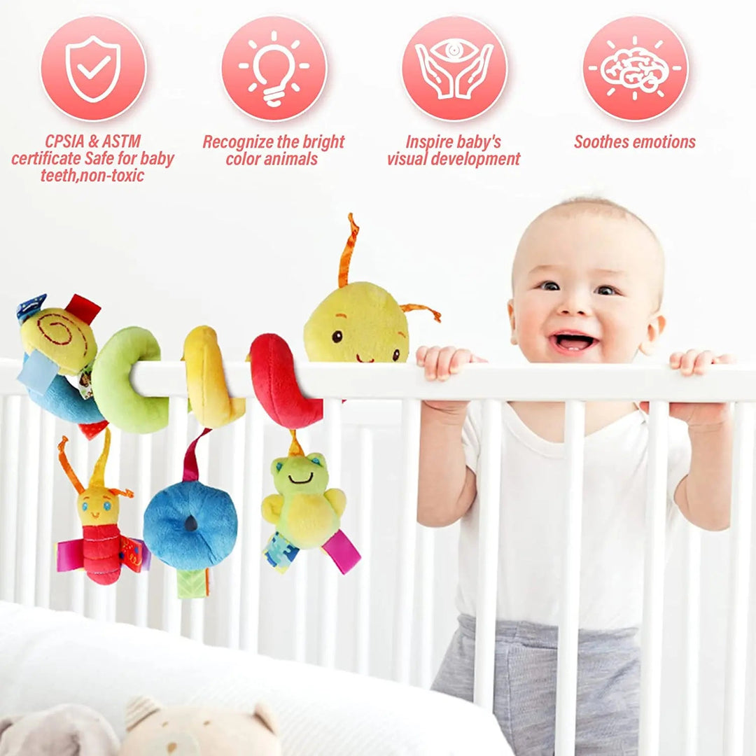 Baby beside a caterpillar spiral activity toy wrapped around a white crib rail
