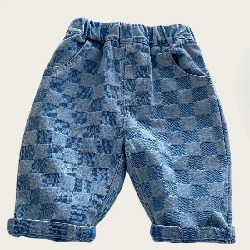 Front of blue checkerboard cotton pants with an elastic waistband and rolled hems