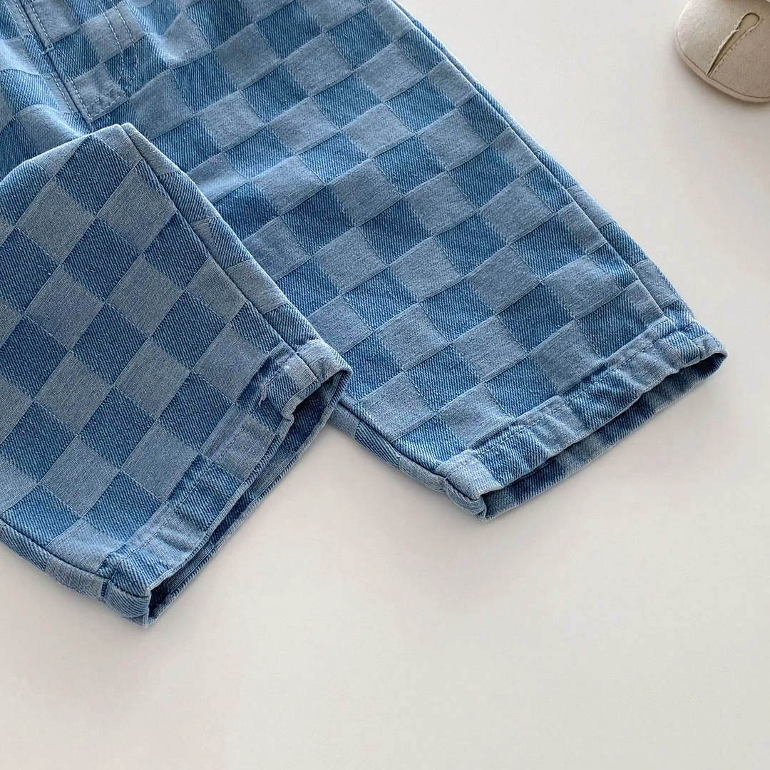 Blue checkerboard pant legs showing the stitched hems