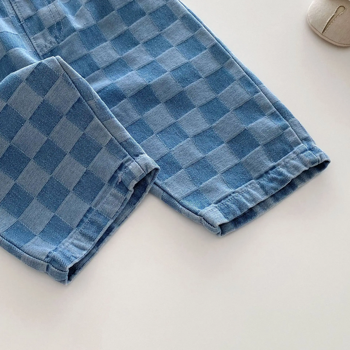 Blue checkerboard pant legs showing the stitched hems