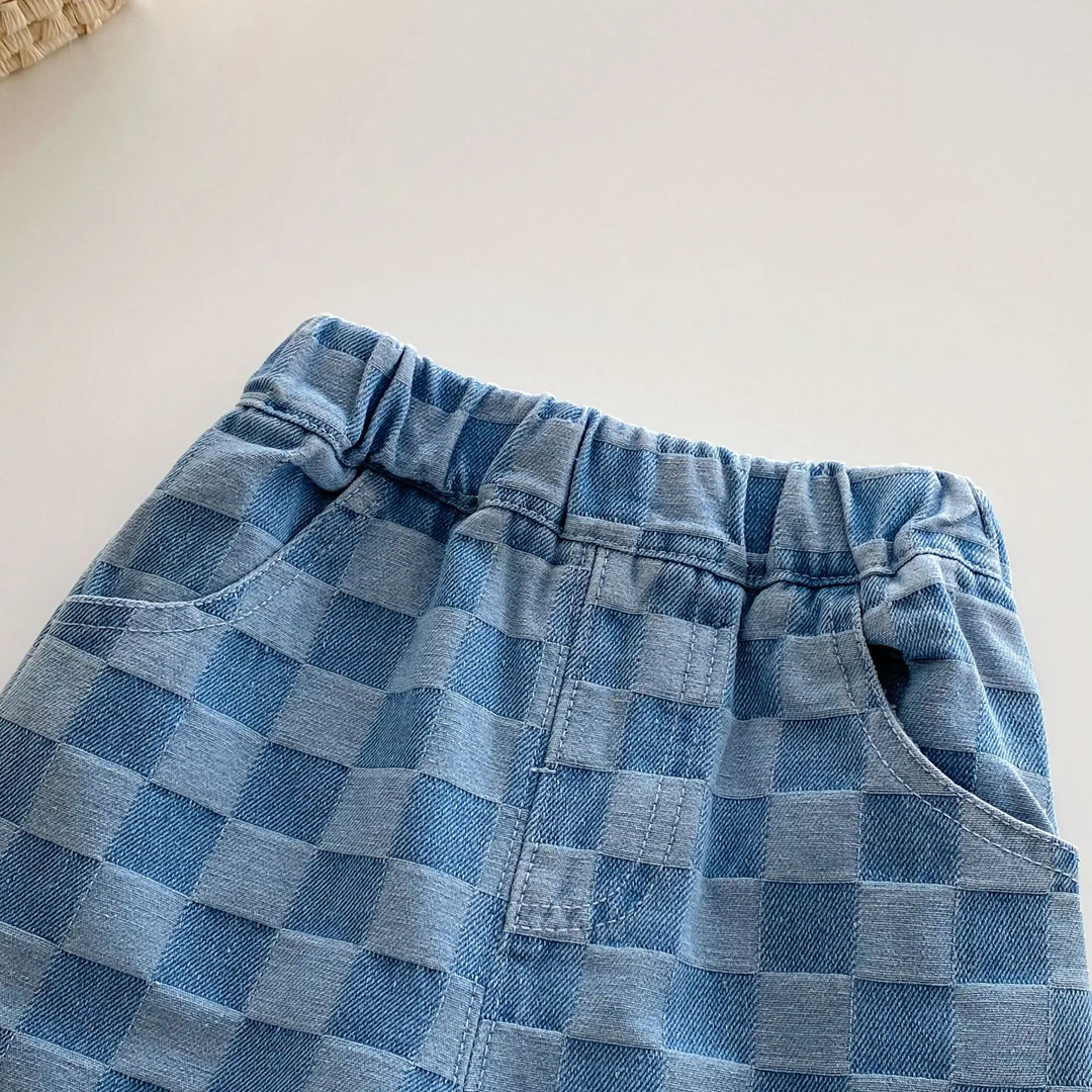 Close-up of the front waistband and pockets on blue checkerboard kids&
