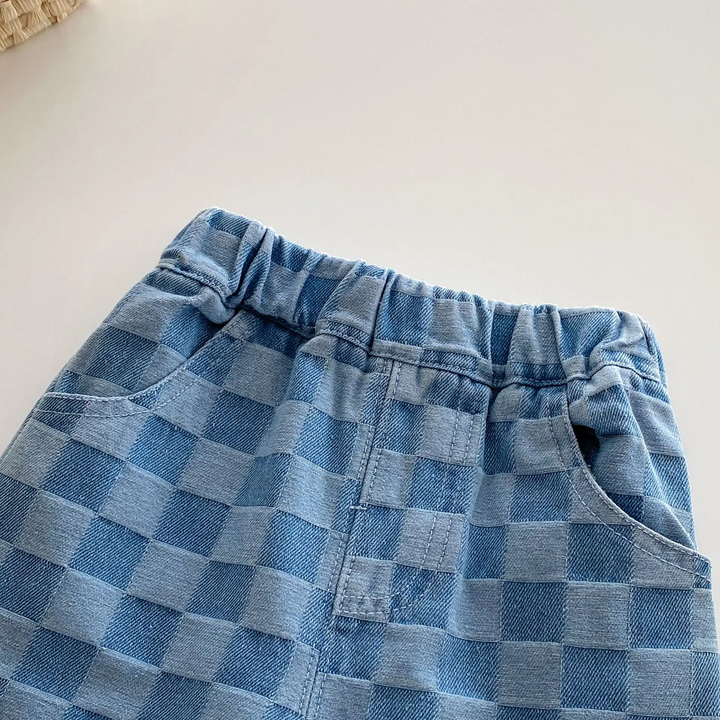 Close-up of the front waistband and pockets on blue checkerboard kids&