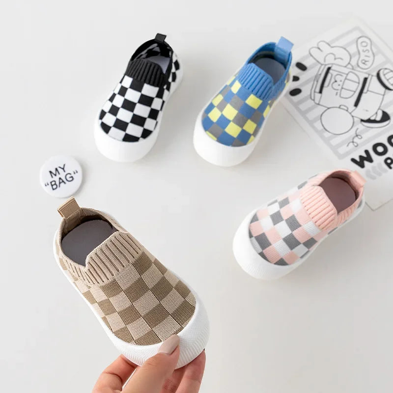 Four checkered slip-on color combinations, with a brown-beige shoe held in the foreground