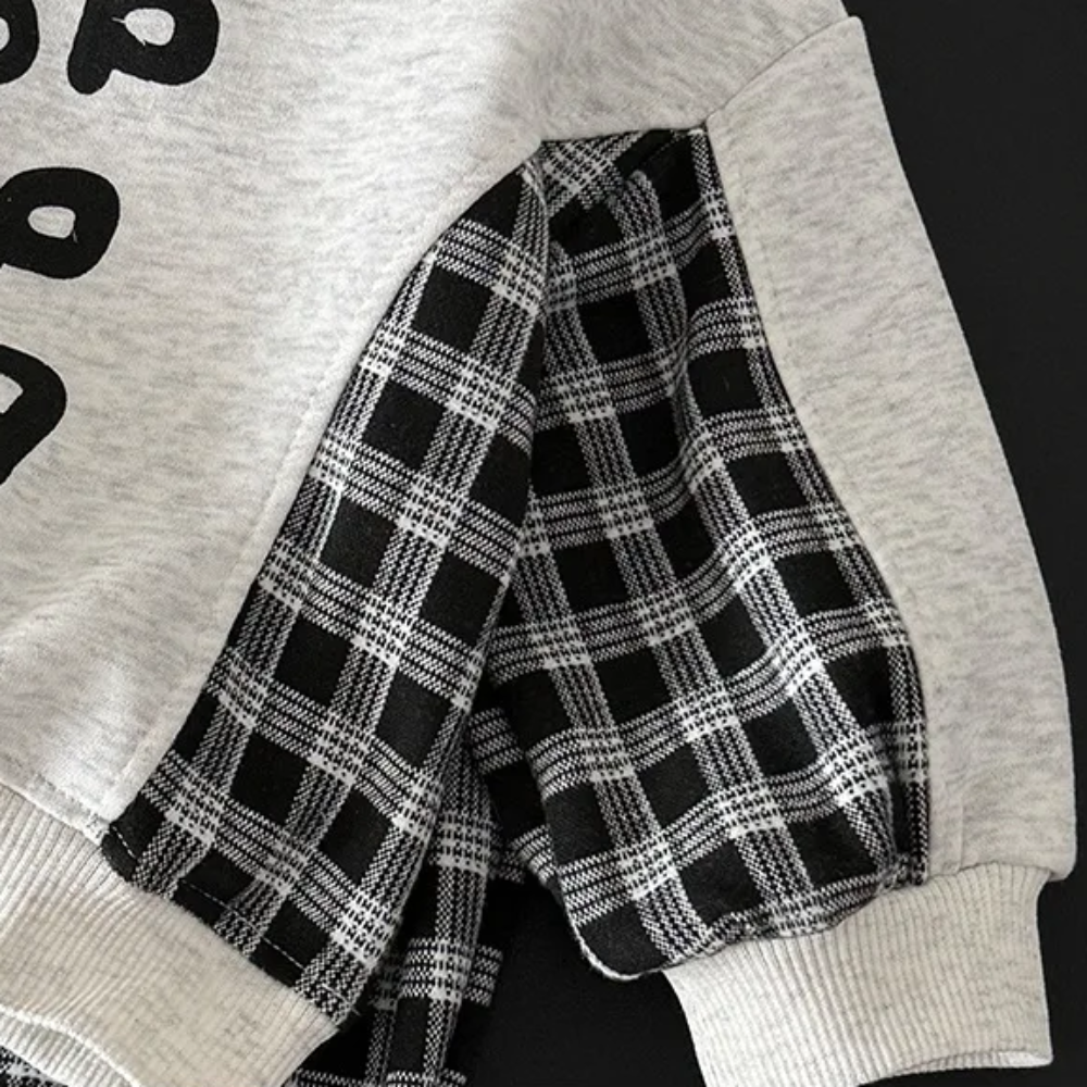 Checkered sweatshirt sleeve with a gray ribbed cuff and contrast upper sleeve