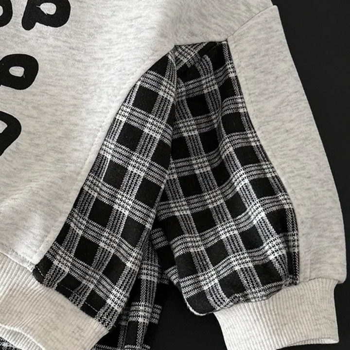 Checkered sweatshirt sleeve with a gray ribbed cuff and contrast upper sleeve