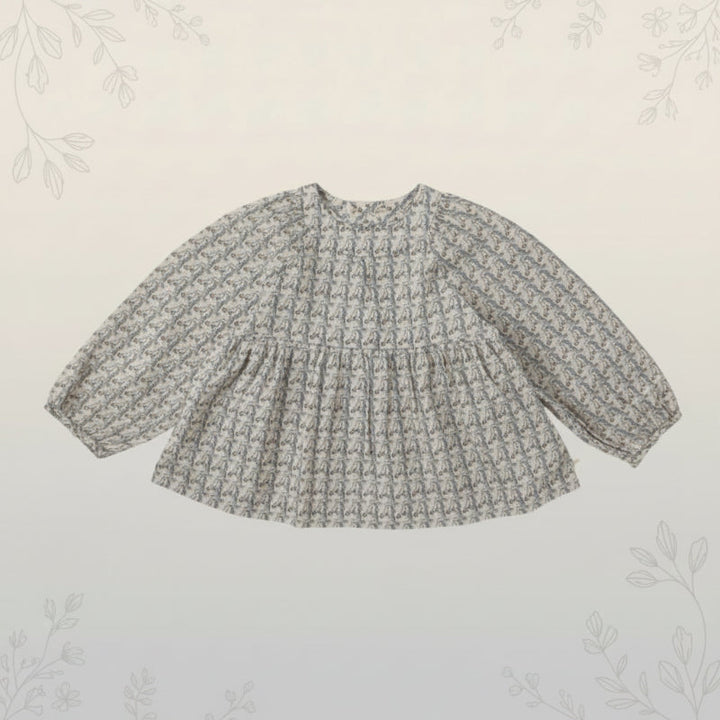 Front view of a printed pullover blouse with long sleeves and a gathered waist