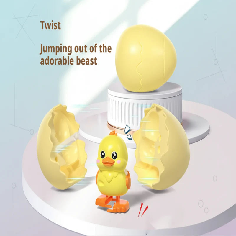 Yellow chick pop-out toy beside an opened yellow egg shell