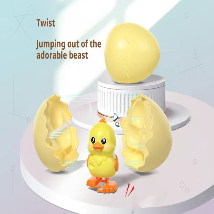 Yellow chick pop-out toy beside an opened yellow egg shell