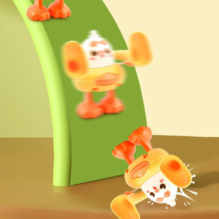 Yellow-and-white chick toy shown upright and mid-flip beside a green backdrop
