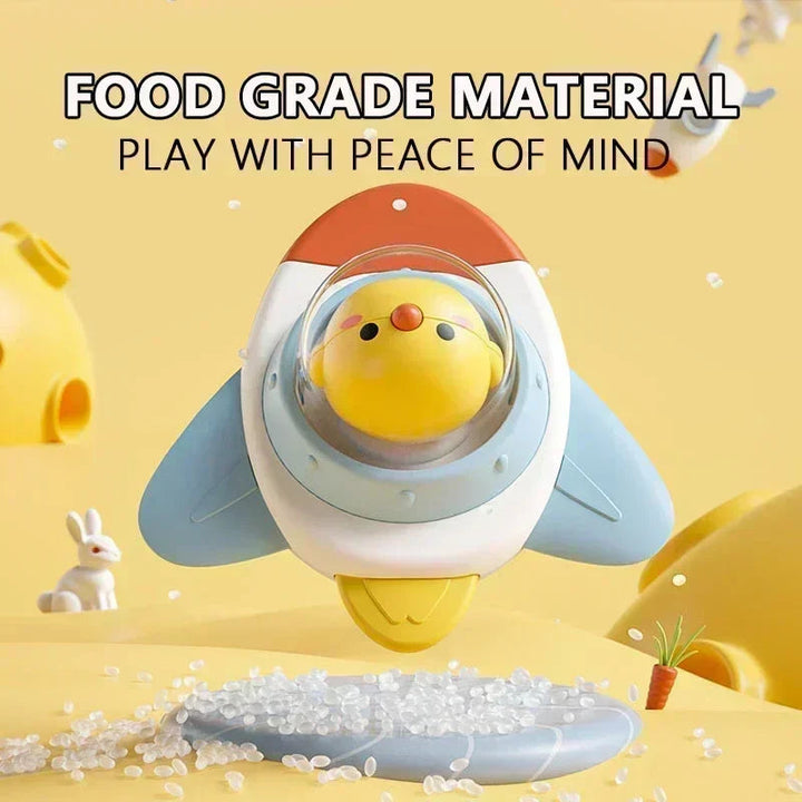 Chicken character under a clear dome on a blue, white, and orange rocket-shaped spinner