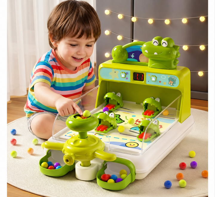 Child playing with the rotating launcher on a green crocodile pinball game
