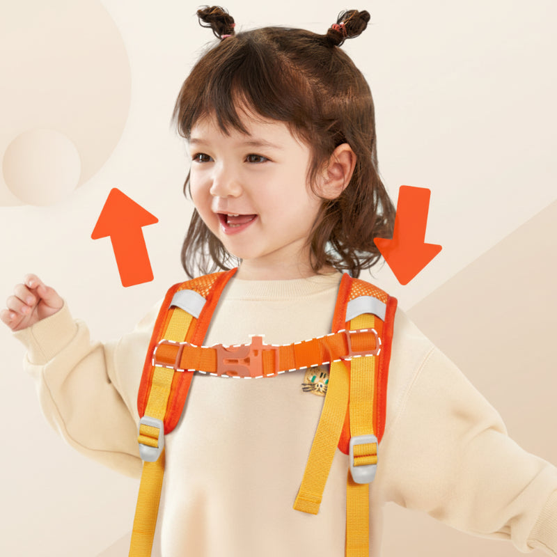 Child wearing a backpack with an orange buckled chest strap