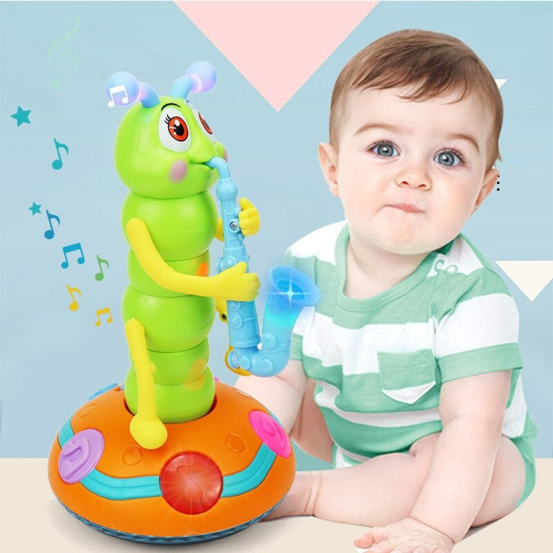 Child seated beside a green caterpillar toy with a blue saxophone