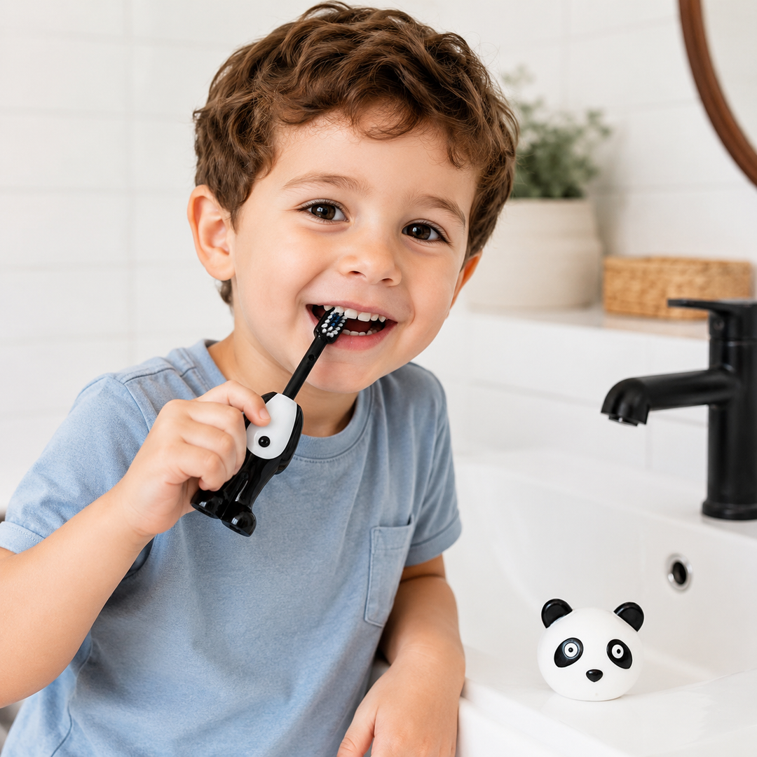 Child brushing with a panda toothbrush, with the panda-head cover beside the sink