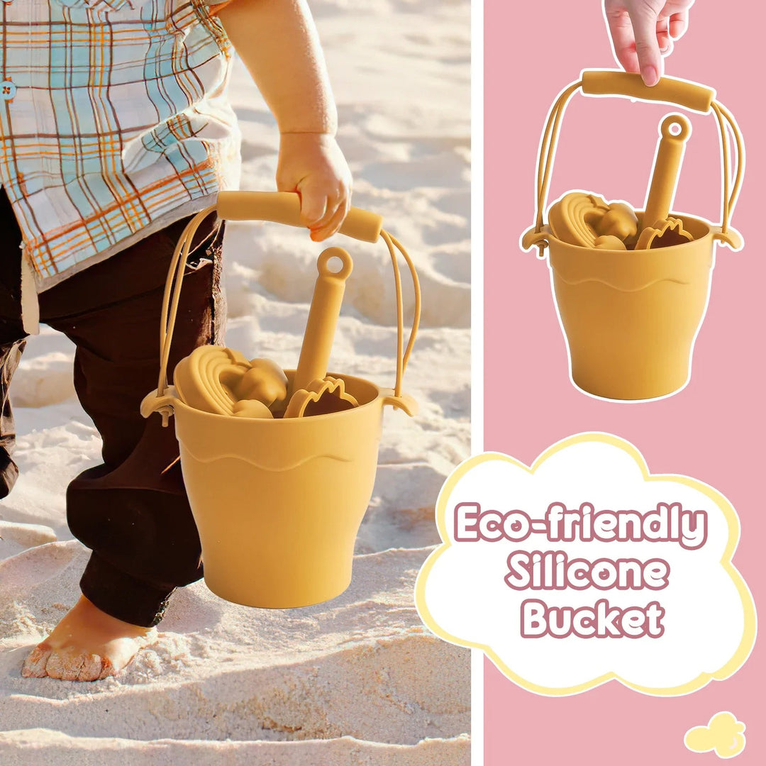 Child carrying a yellow silicone beach bucket filled with a shovel and sand molds.