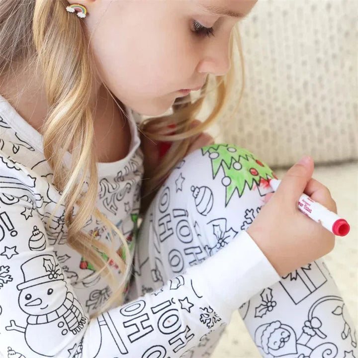 Child using a red marker to color Christmas-themed pajamas