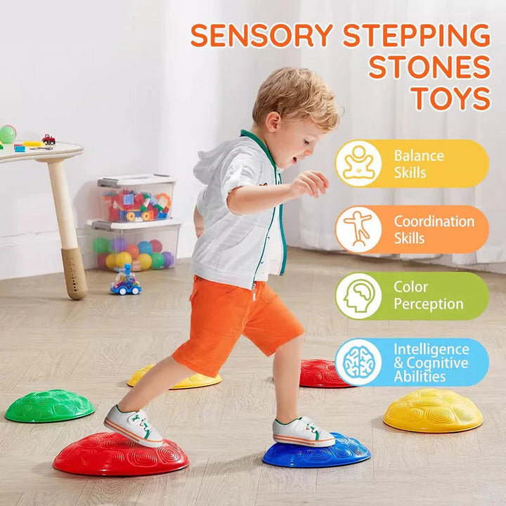 Child stepping between red and blue textured balance stones indoors