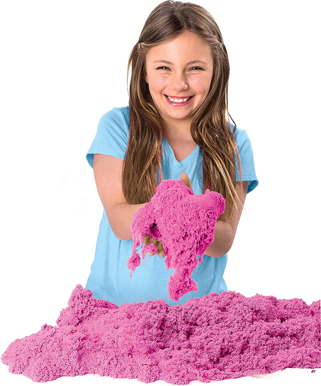Child letting pink play sand crumble through her hands