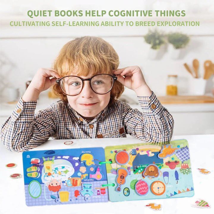 Child sitting behind an open busy book with colorful activity pages