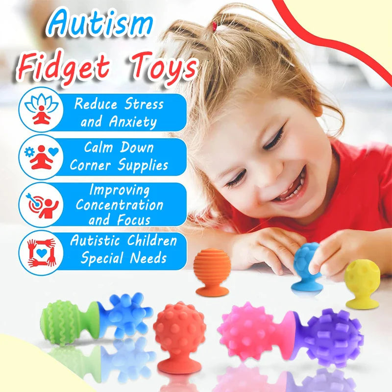 Child holding a blue textured round fidget beside assorted colorful silicone sensory pieces