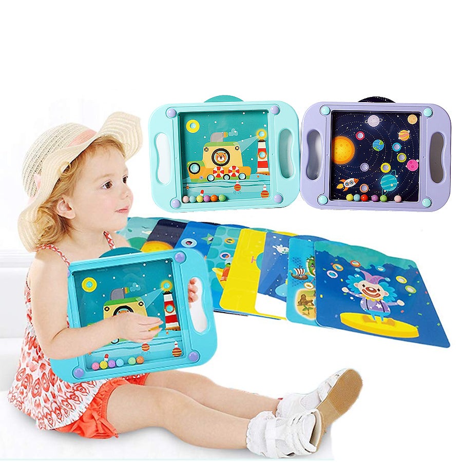 Child holding a green maze board beside illustrated cards and green and purple game boards