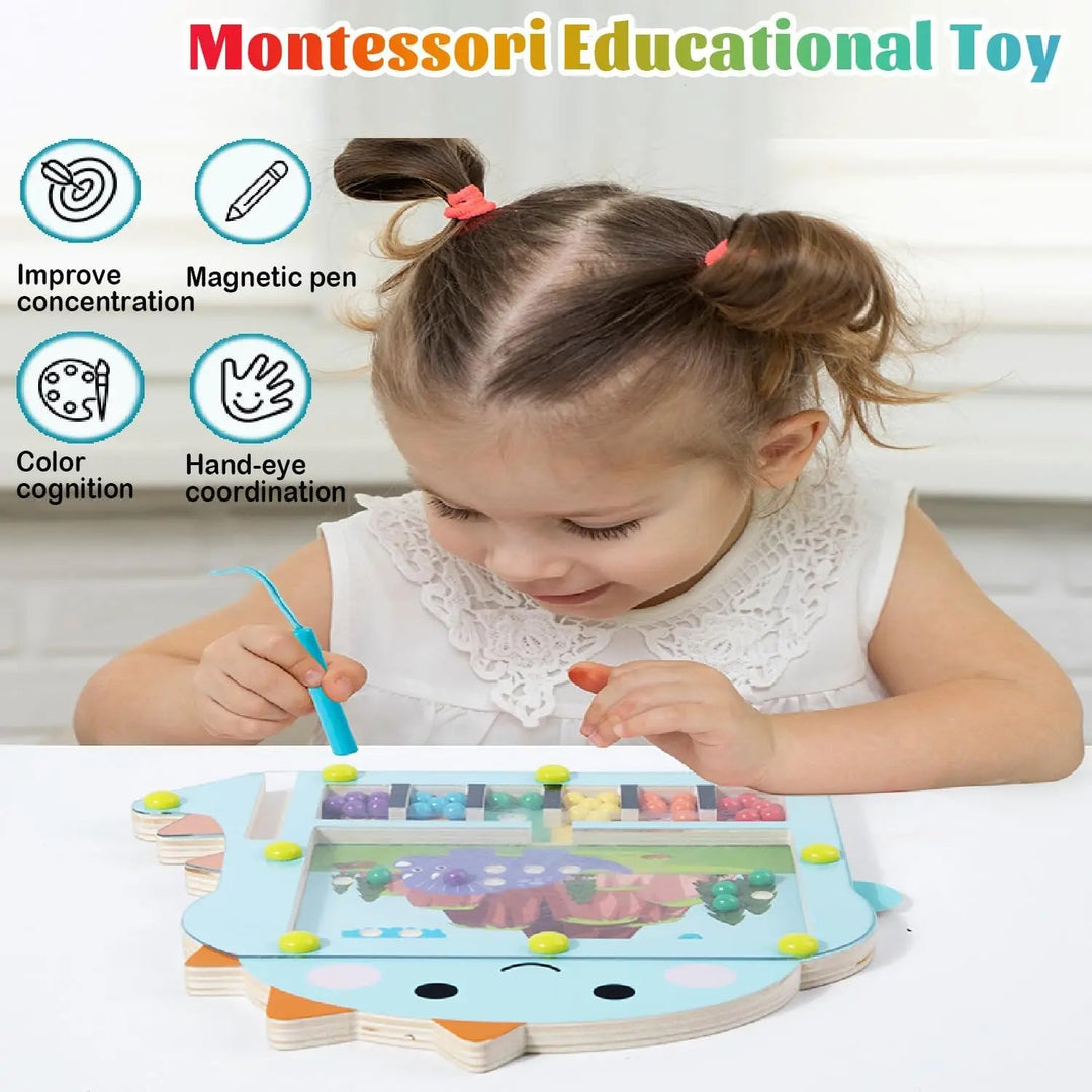 Child using a magnetic pen to move colorful beads on a dinosaur-shaped board