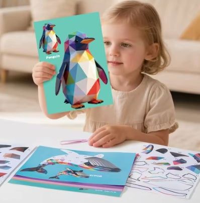 Child holding a completed geometric penguin sticker picture