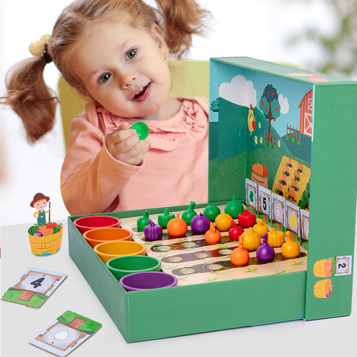 Child holding a green vegetable piece beside the farm counting game and colorful sorting cups