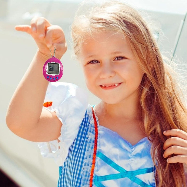 Child holding a pink egg-shaped digital pet toy by its ball chain.