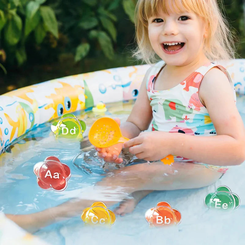 Child holding a yellow flower-shaped piece while colorful alphabet letters float in a small pool.