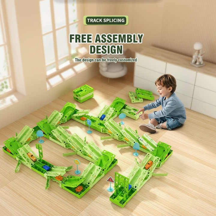 Child beside a large green race track layout on a wooden floor