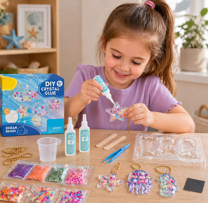 Child crafting a sea-themed resin keychain with molds, glitter, and beads on the table
