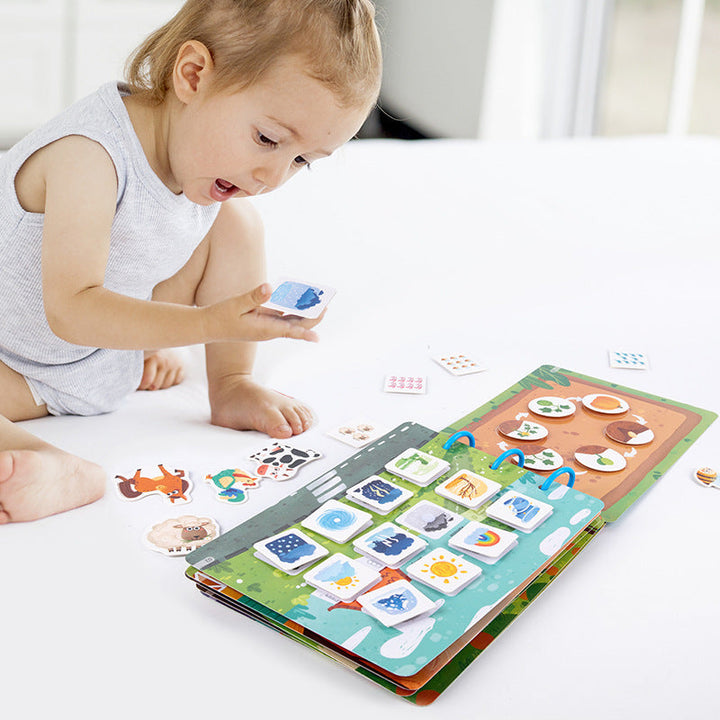 Child matching picture pieces on an open farm activity book