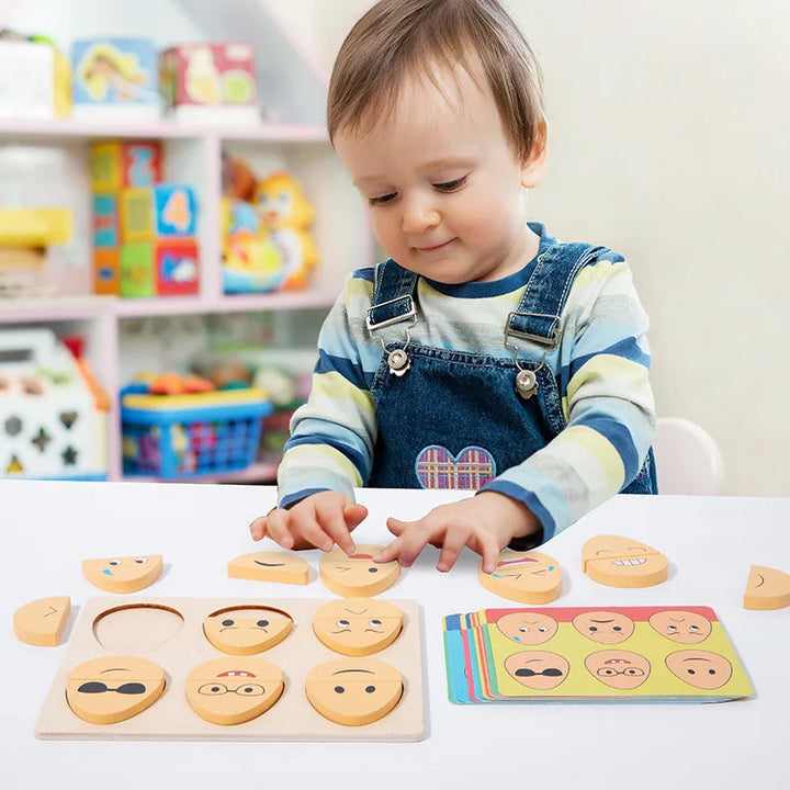 Child fitting wooden face pieces into the expression puzzle board beside matching cards