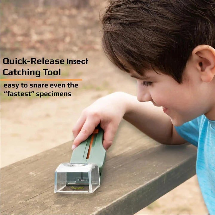 Child using the long-handled bug catcher on a wooden surface