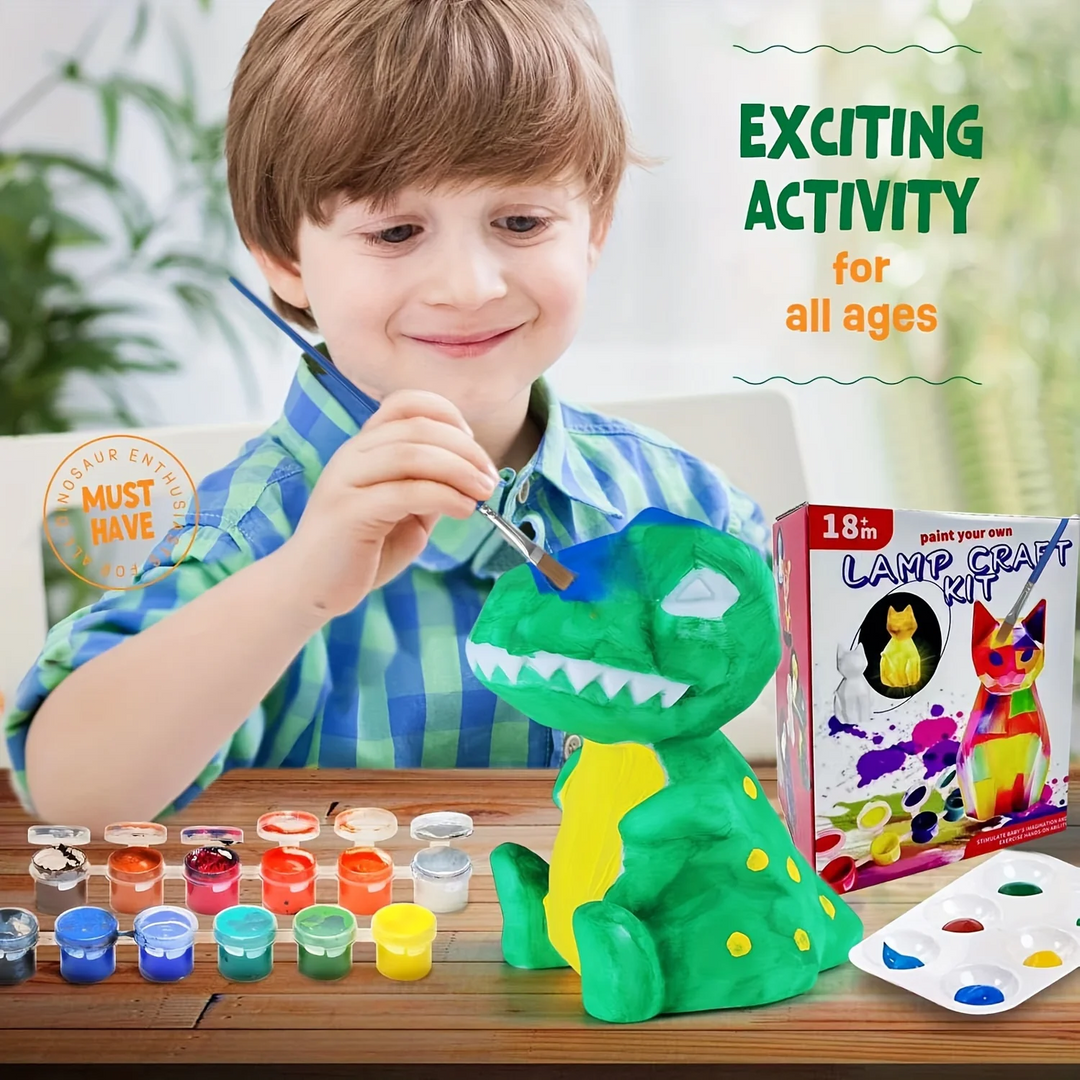 Child painting a green dinosaur lamp at a table with colorful paints, brushes, and palettes.