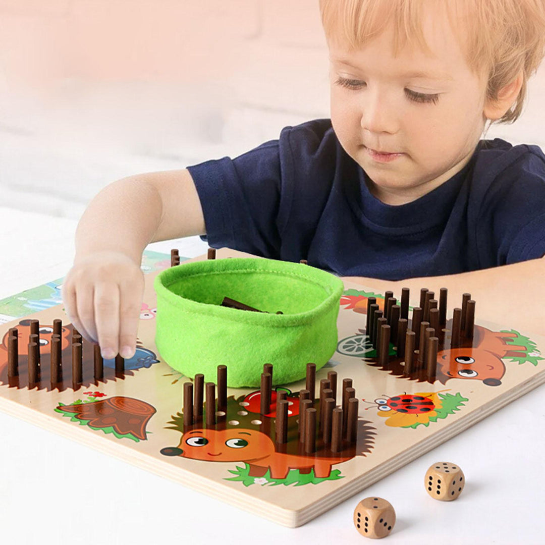 Child placing counting sticks in a hedgehog board with two dice beside it