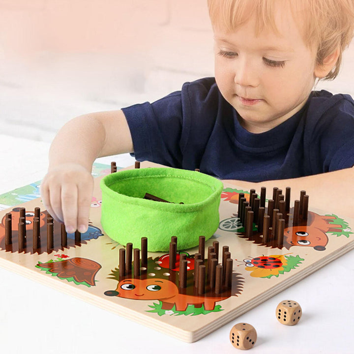 Child placing counting sticks in a hedgehog board with two dice beside it