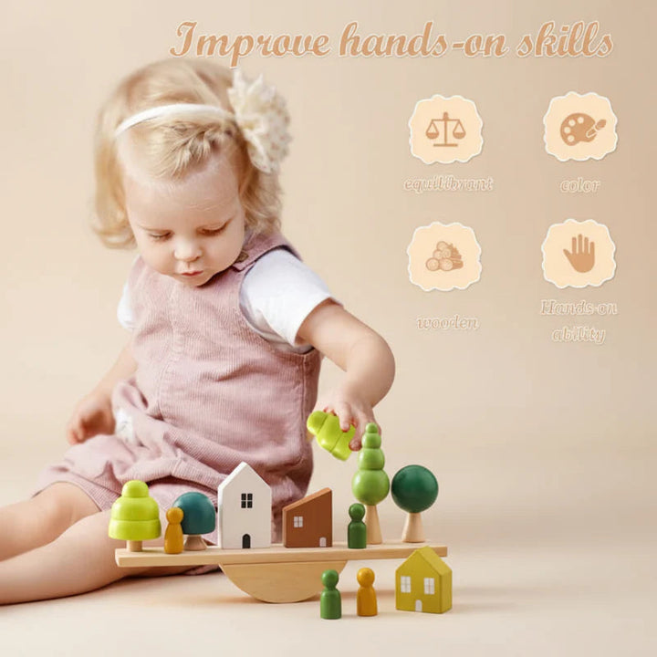 Child placing a green tree on a wooden balancing board with house pieces