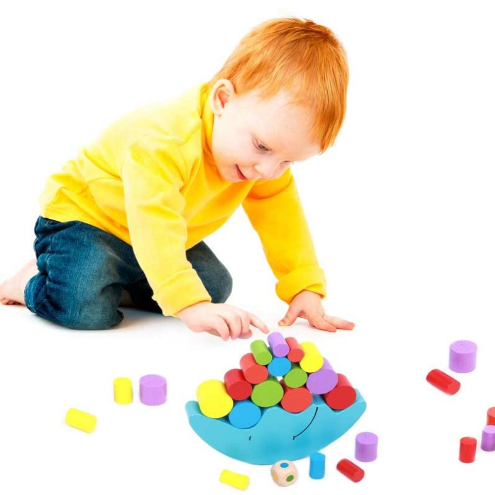 Child playing with a blue crescent balancing base and colorful wooden blocks