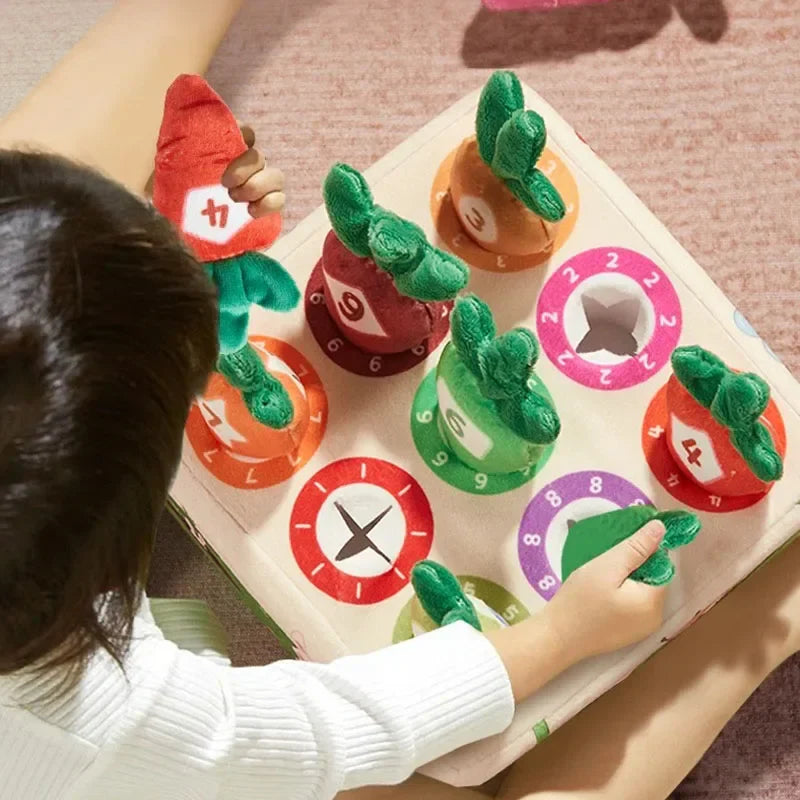 Child placing colorful numbered plush carrots in a matching garden board